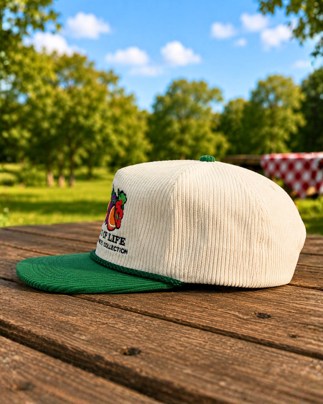 Fruits of Life corduroy hat in cream and green with embroidered fruit logo