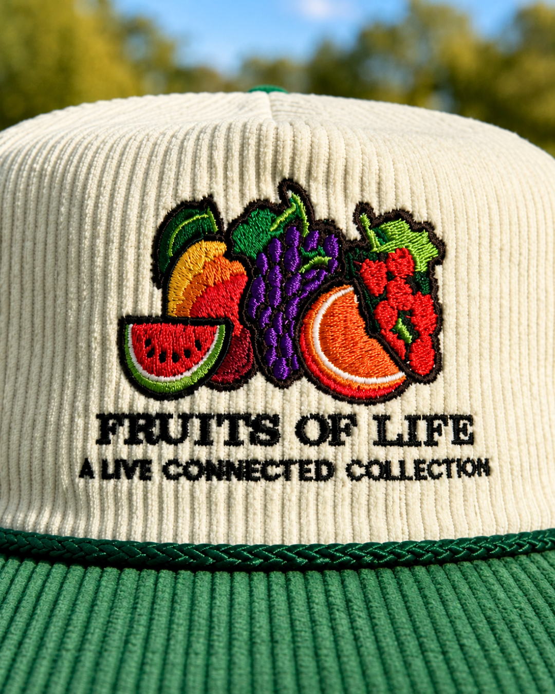Fruits of Life corduroy hat in cream and green with embroidered fruit logo
